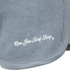 Close-up of a denim blue garment with the logo Ron Jon Surf Shop printed in white cursive text at the bottom.