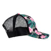 A side view of a trucker hat with a black mesh back and a floral-patterned front and brim featuring pink flowers and green leaves. Seen from the right.