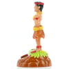 Plastic hula dancer figurine wearing a grass skirt and flower accessories, standing on a brown and green base, viewed from the side.