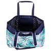 Large tote bag with blue handles, tropical leaf pattern in shades of green and pink on the exterior, and black and white geometric interior lining.