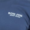Close-up of a blue shirt with a white Ron Jon Surf Shop logo on it.
