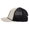 Side view of a beige and black trucker cap with a mesh back and a rectangular patch on the front.