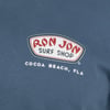 Blue shirt with the Ron Jon Surf Shop logo, featuring red and white text. Below, it says Cocoa Beach, Fla.