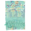 Light green sarong with a multicolor floral and abstract pattern, yellow and purple accents, and tassels along one edge.