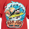 Graphic of a shark with a surfboard in its mouth, surrounded by waves and palm trees, on a red background. Text: Ron Jon Surf Shop.