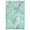 A folded light teal fabric with a floral pattern in purple, white, and yellow shades.