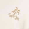 Beige graphic of a turtle above text Ron Jon on a white fabric background.