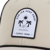 Close-up of a beige cap with a Ron Jon Surf Shop patch. The patch features a sun, palm trees, water, and a skull, with Since 1959 written below.