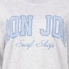 Close-up of a light gray shirt featuring the text RON JON Surf Shop in blue and white plaid and cursive lettering on the front.