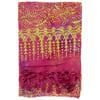 A folded pink and yellow patterned fabric with leafy and dotted designs and tassels along one edge.