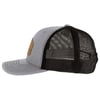 Side view of a gray and black trucker hat with a curved brim and mesh back, featuring a brown leather patch on the front.