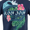Close up of a navy blue t-shirt with a colorful “Ron Jon Surf Shop” graphic featuring a wave, pink hibiscus flowers, and green tropical leaves.