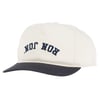 Beige baseball cap with a black brim and the words RON JON printed upside down in blue letters on the front.