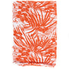 A piece of fabric featuring an orange and white tropical floral and leaf pattern, folded neatly.