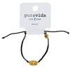Black braided bracelet with a gold Ron Jon Surf Shop logo attached. Pura Vida packaging in the background.