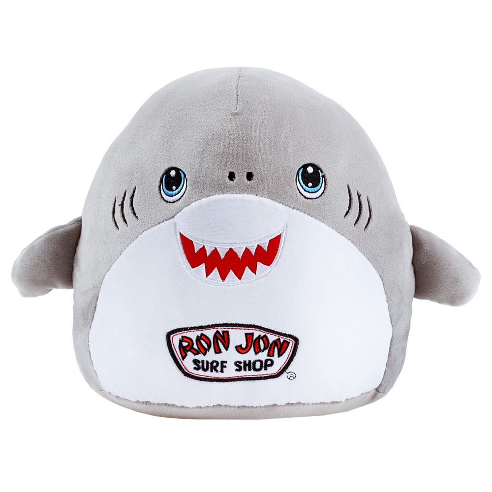 Gray and white plush shark toy with a smiling face, small fins, and a “Ron Jon Surf Shop” patch on its front.