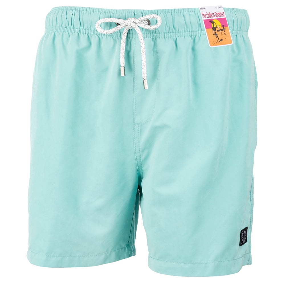 Light blue swim shorts with a white drawstring and a small colorful tag attached to the waistband.