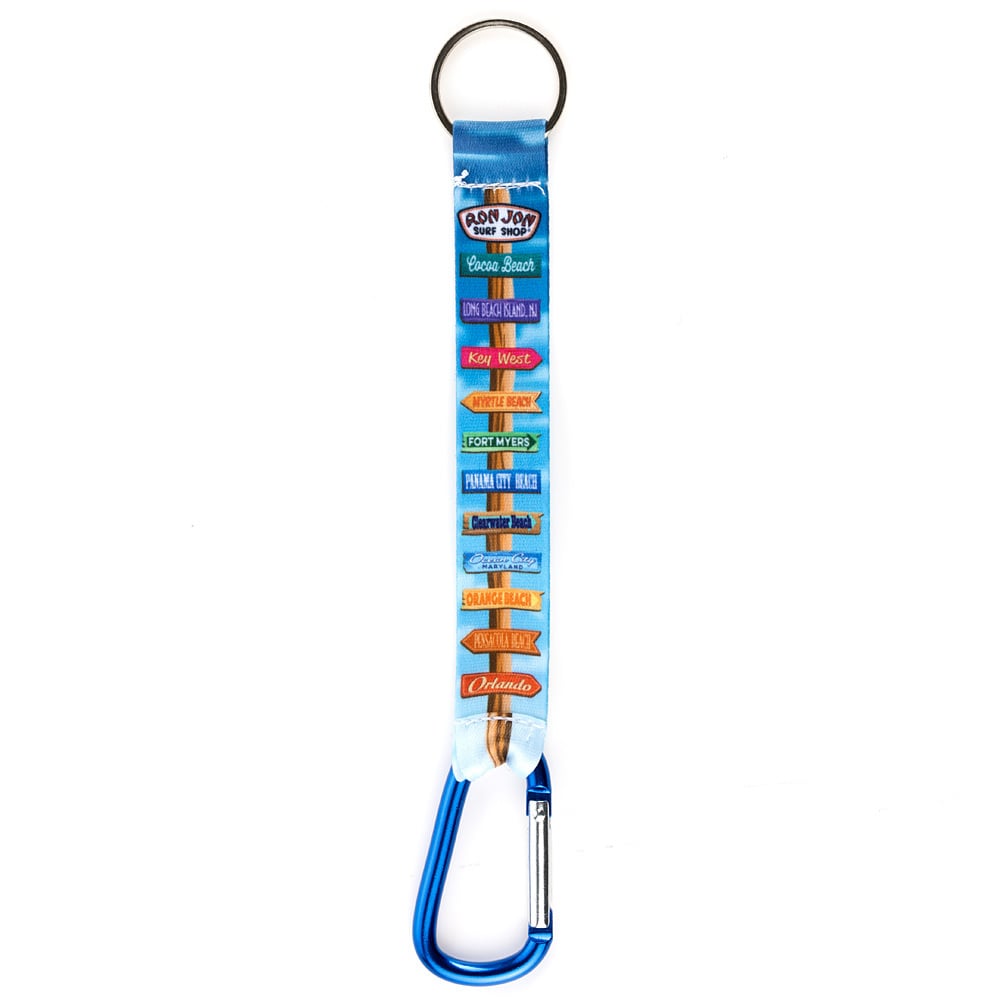 A keychain with a blue carabiner and a fabric strap listing popular Ron Jon destinations in colorful text.