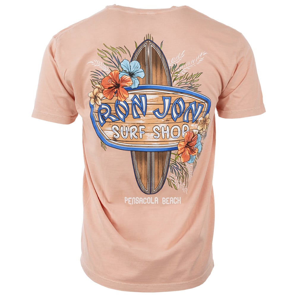 Back of a peach-colored T-shirt featuring a surfboard, flowers, and Ron Jon Surf Shop with Pensacola Beach text underneath.