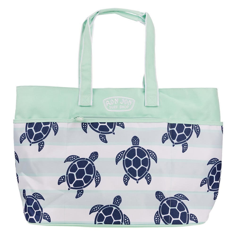 A mint green tote bag with patterned blue sea turtles and the words Ron Jon Surf Shop on the front.