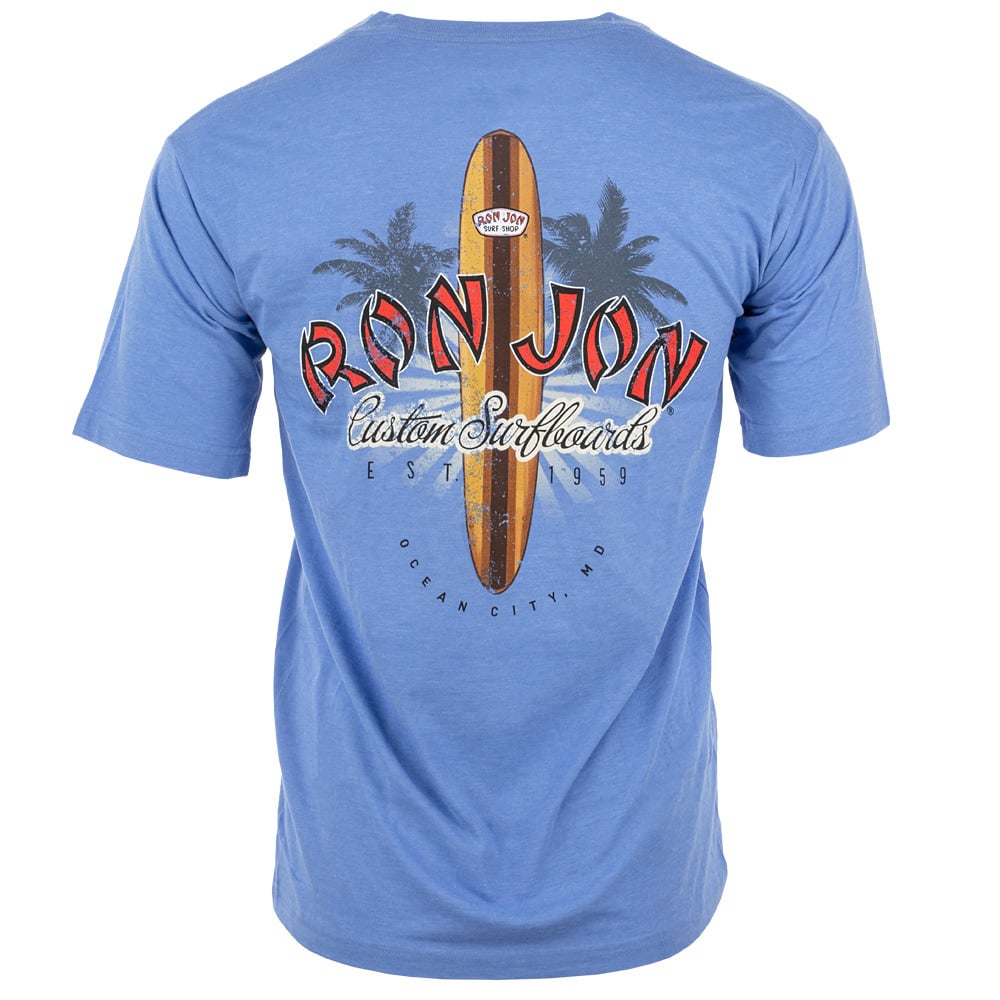 A blue T-shirt featuring a large graphic on the back with a surfboard, palm trees, and the text Ron Jon Custom Surfboards, Est. 1959, Ocean City MD.