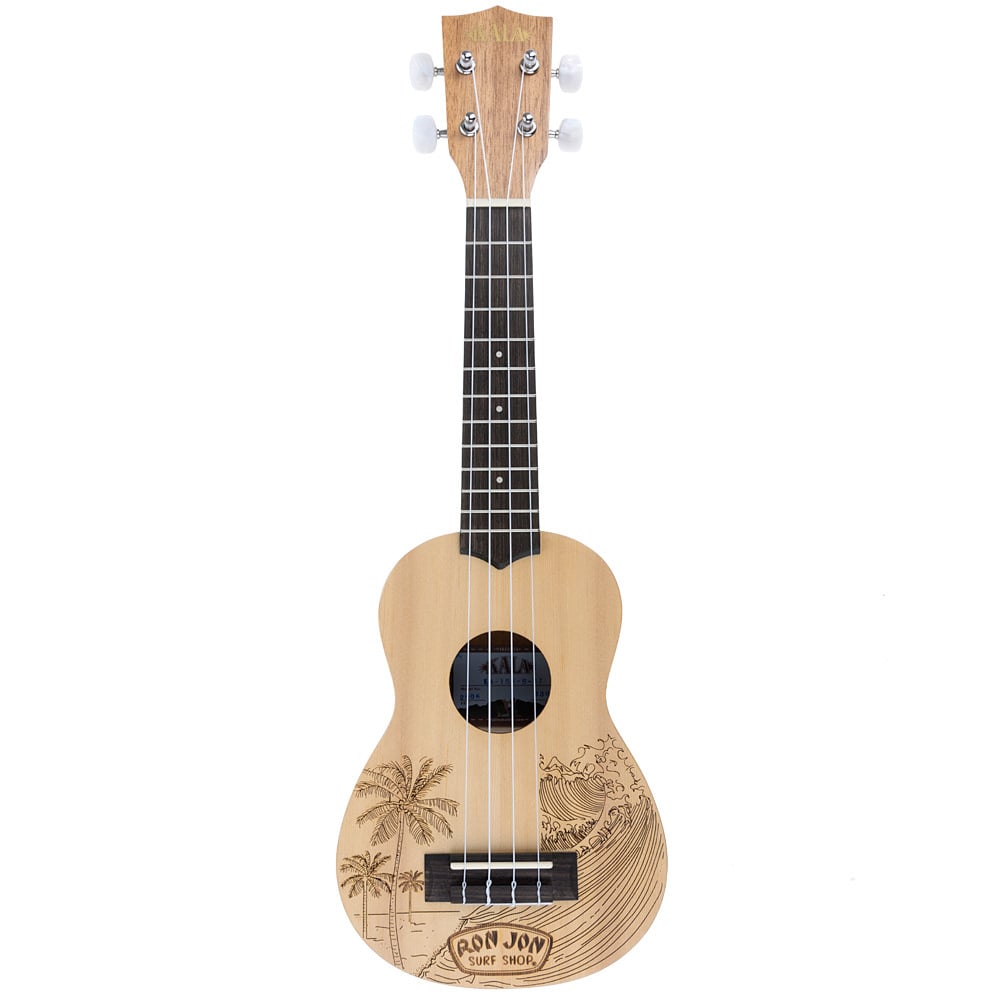 A light wood ukulele with black tuning pegs and strings, featuring a palm tree and wave design above the Ron Jon Surf Shop logo on the body.