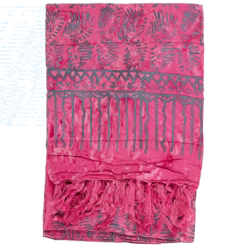 A pink sarong with gray geometric and leaf patterns, featuring fringed tassels along one edge.