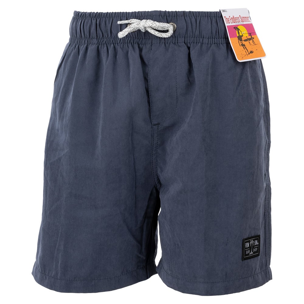 Dark blue swim shorts with a drawstring waist and a patch on the left leg. A brand tag is attached to the waistband.