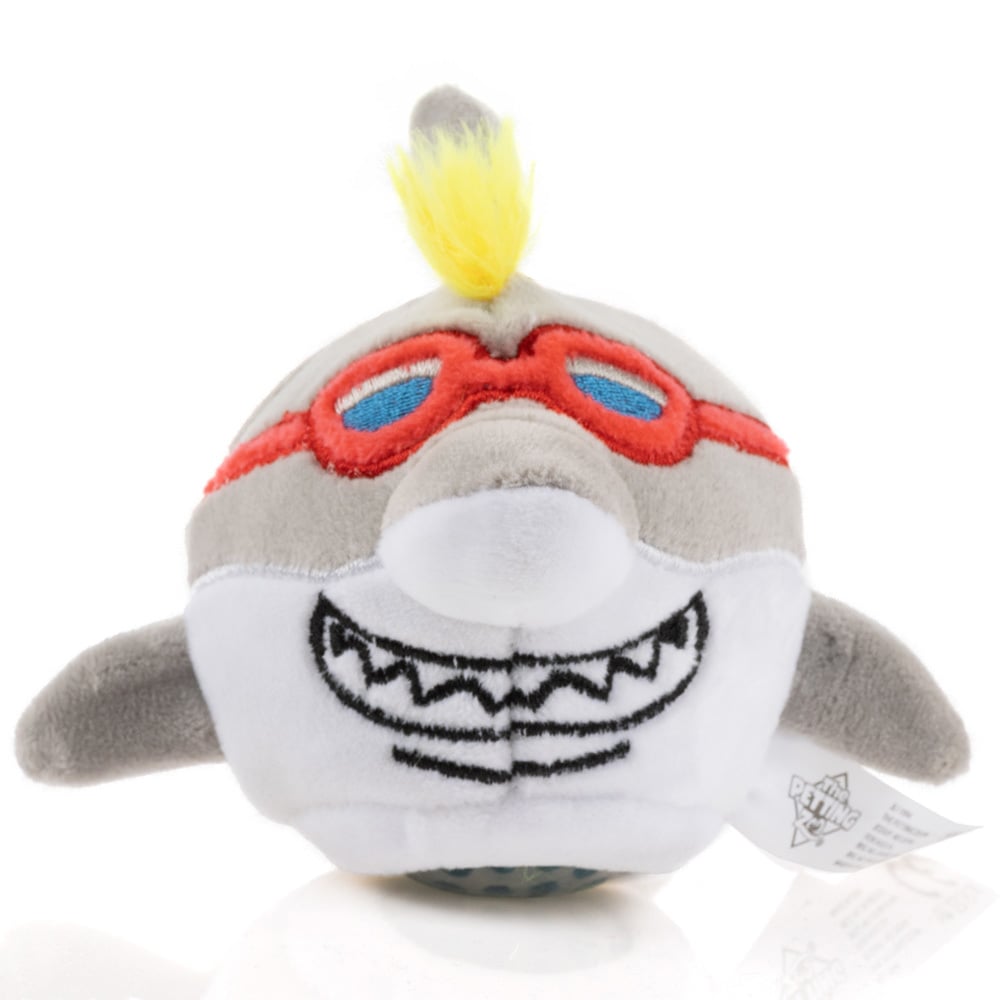 Plush shark toy with red goggles, white belly, and a yellow tuft of hair on top.
