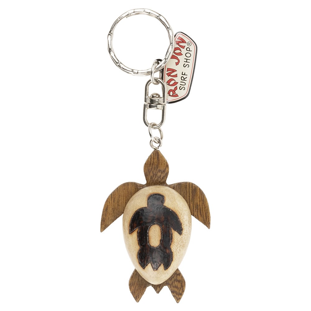 A keychain with a wooden sea turtle pendant and a metal tag that reads RON JON SURF SHOP.