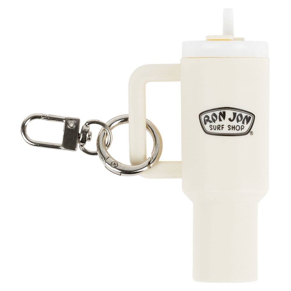 A cream-colored keychain shaped like a tumbler with a handle, featuring the Ron Jon Surf Shop logo and a metal keyring with a clasp.