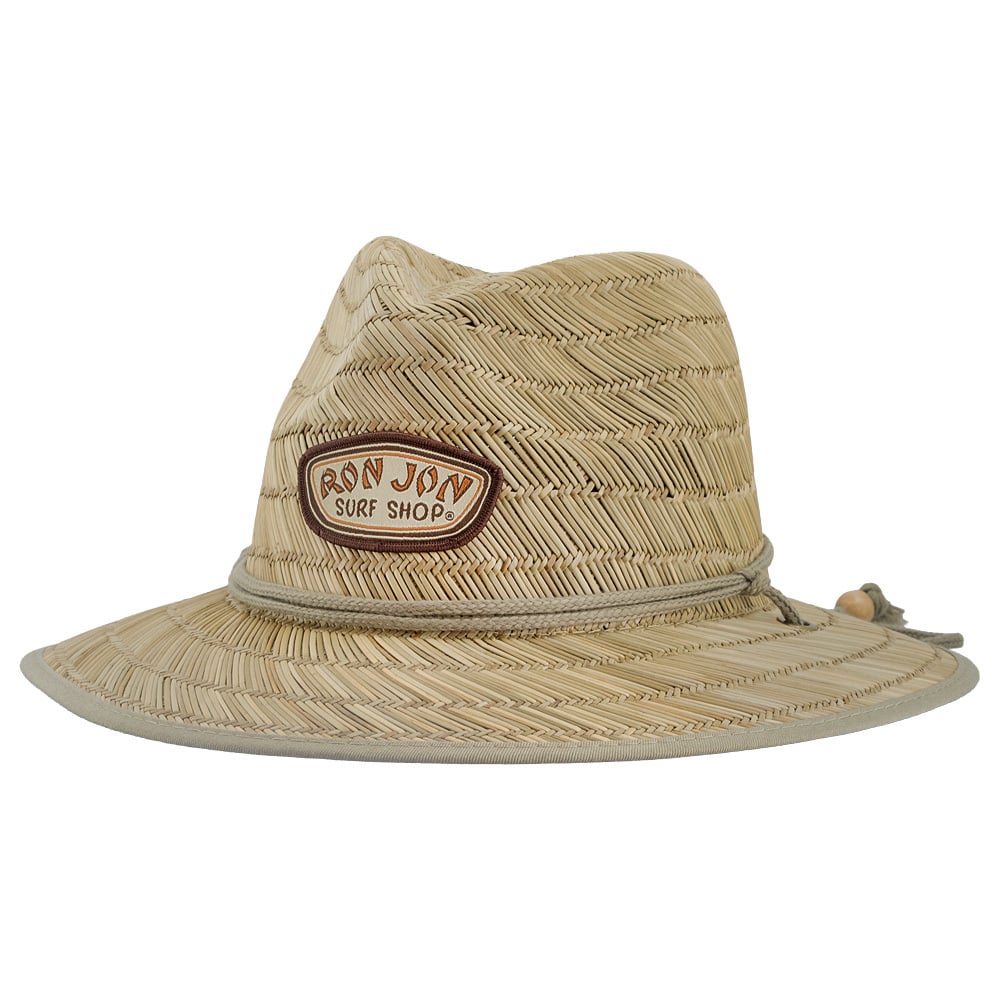 A woven straw hat with a wide brim, featuring a patch that reads “Ron Jon Surf Shop” on the front and a chin cord with a bead.