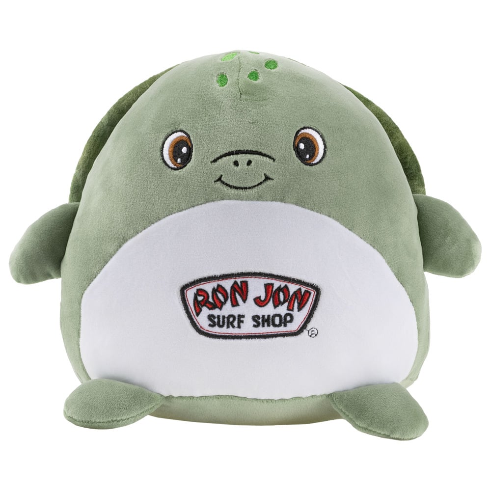 A green plush turtle with a smiling face and Ron Jon Surf Shop logo on its white belly.