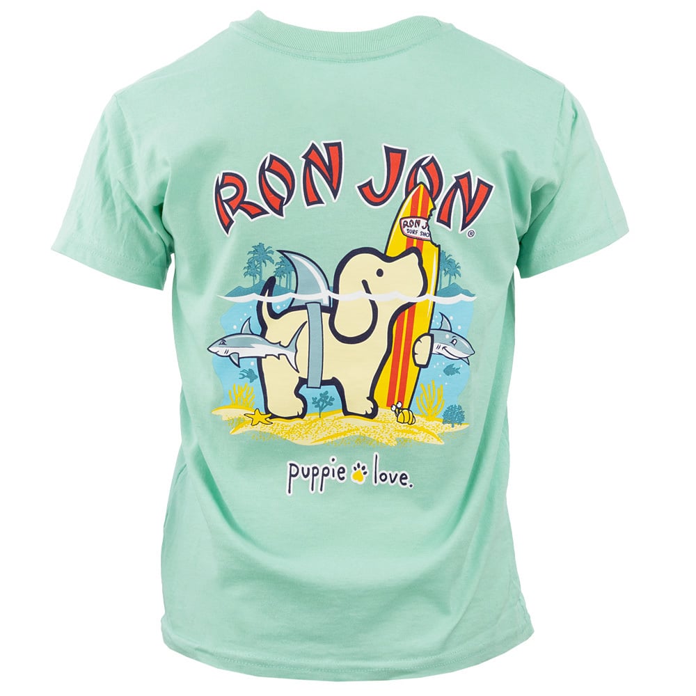 A mint green t-shirt with a cartoon dog holding a surfboard, surrounded by fish and palm trees, and the text RON JON and puppie love.