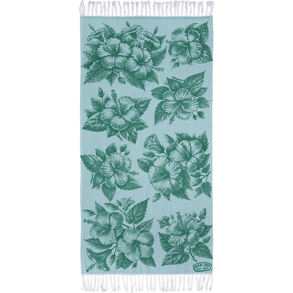 A rectangular light blue towel with white fringe on both ends, featuring a repeating green floral pattern with large hibiscus flowers and leaves.