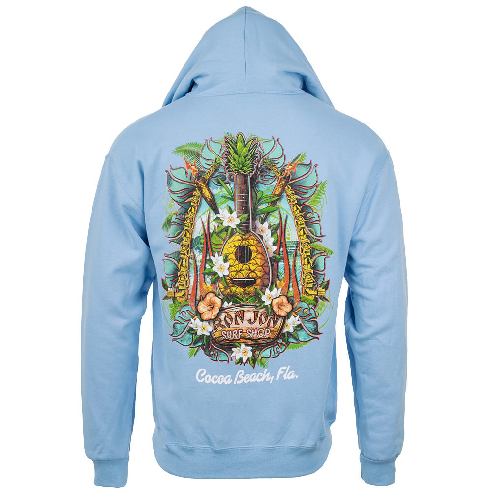 A light blue hoodie featuring a colorful back graphic with palm trees, flowers, a pineapple, surfboards, and text reading Cocoa Beach Surf Shop, Cocoa Beach, Fla.