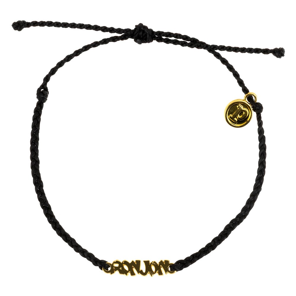Black braided bracelet with a gold-tone charm and circular pendant featuring a design.
