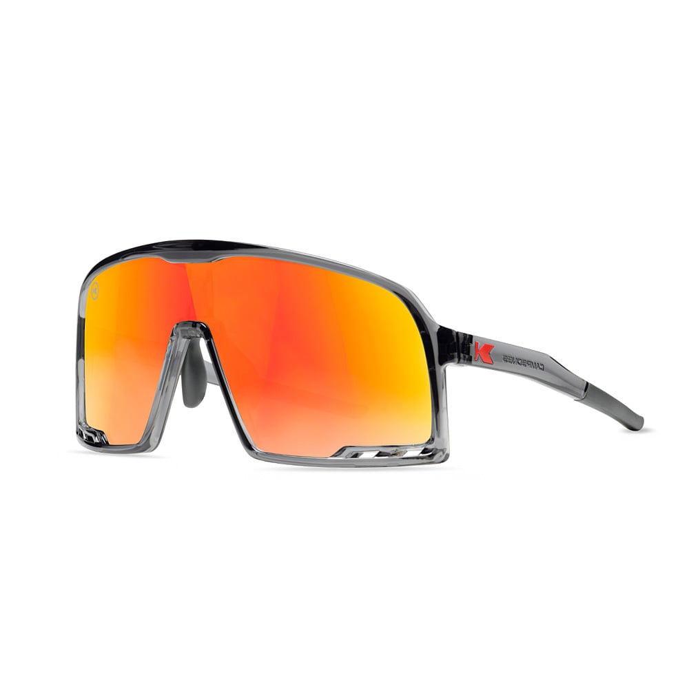 Knockaround gray sports sunglasses with large red-orange lenses and black arms, displayed on a white background.