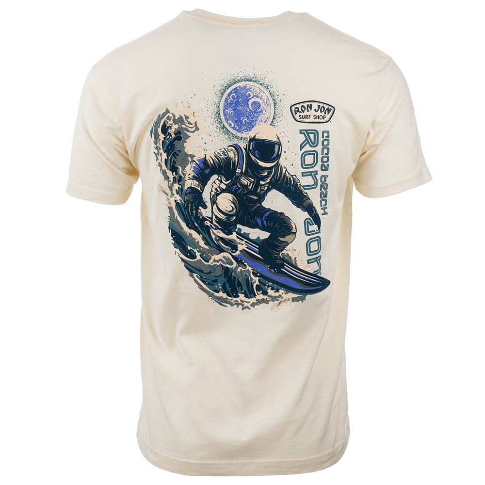 Beige T-shirt featuring an illustration of an astronaut surfing on a wave with a planet in the background, and Ron Jon Surf Shop text.