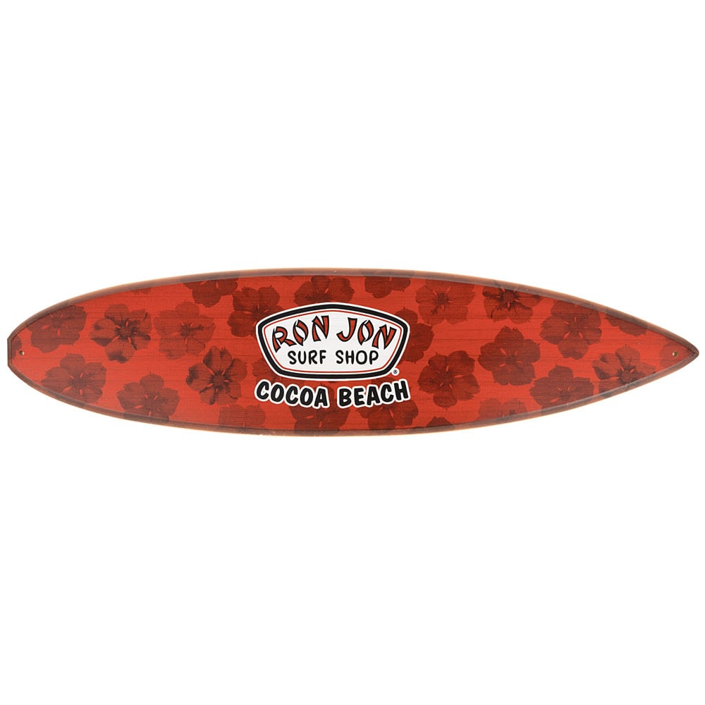 Red surfboard shaped sign with a hibiscus flower pattern and a Ron Jon Surf Shop Cocoa Beach logo in the center.