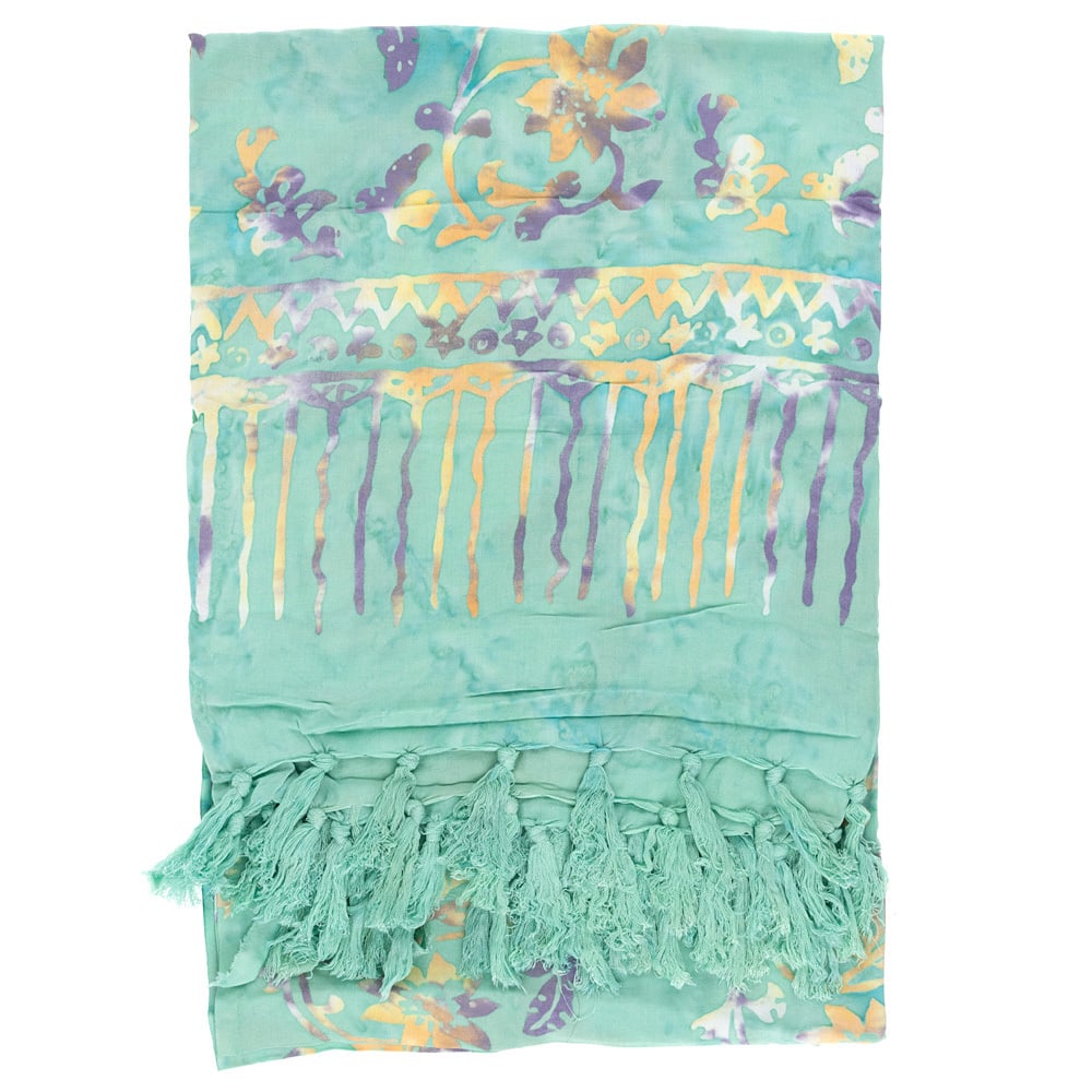 Light green sarong with a multicolor floral and abstract pattern, yellow and purple accents, and tassels along one edge.