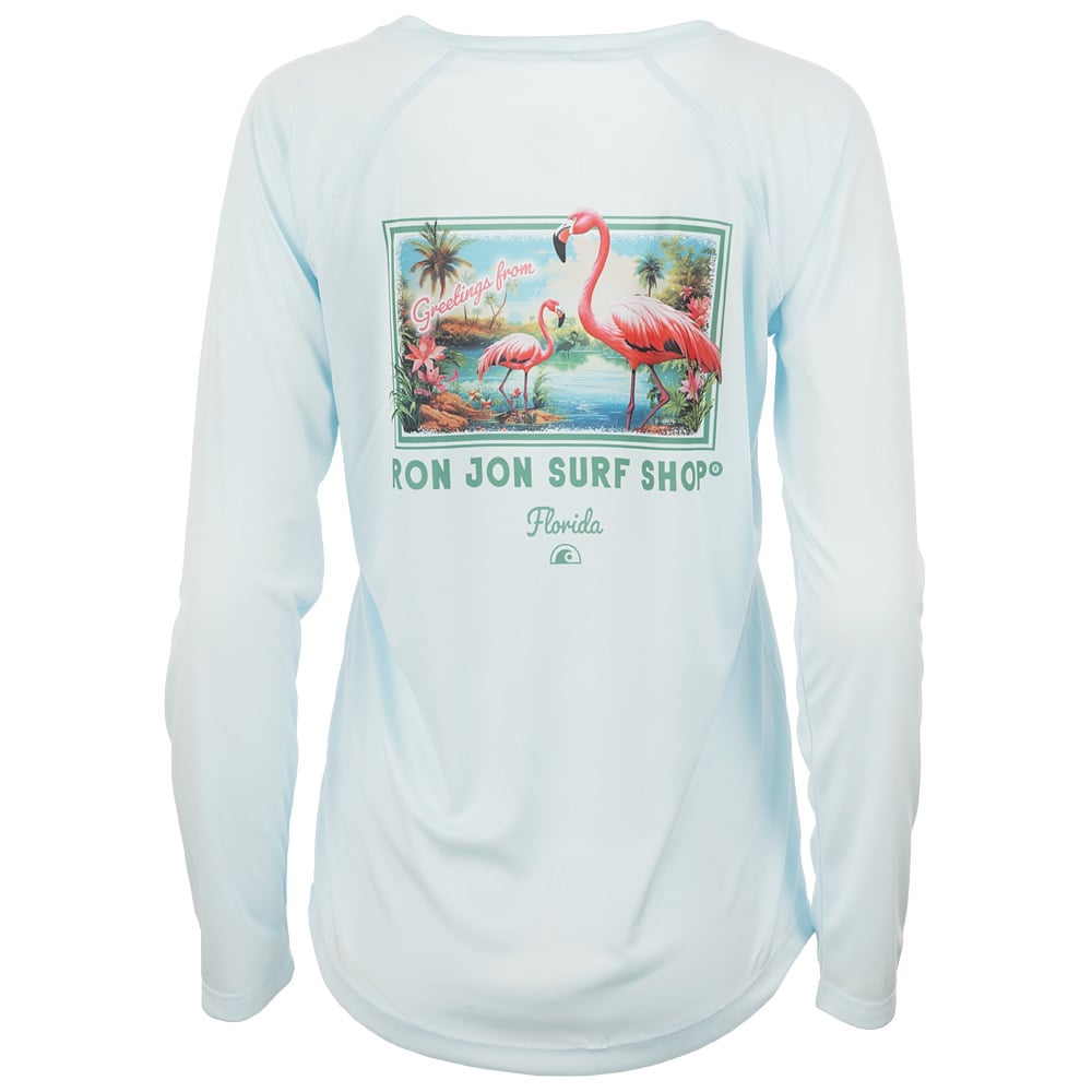 Light blue long-sleeve shirt featuring a graphic of flamingos, palm trees, and water with the text Greetings from Ron Jon Surf Shop Florida on the back.