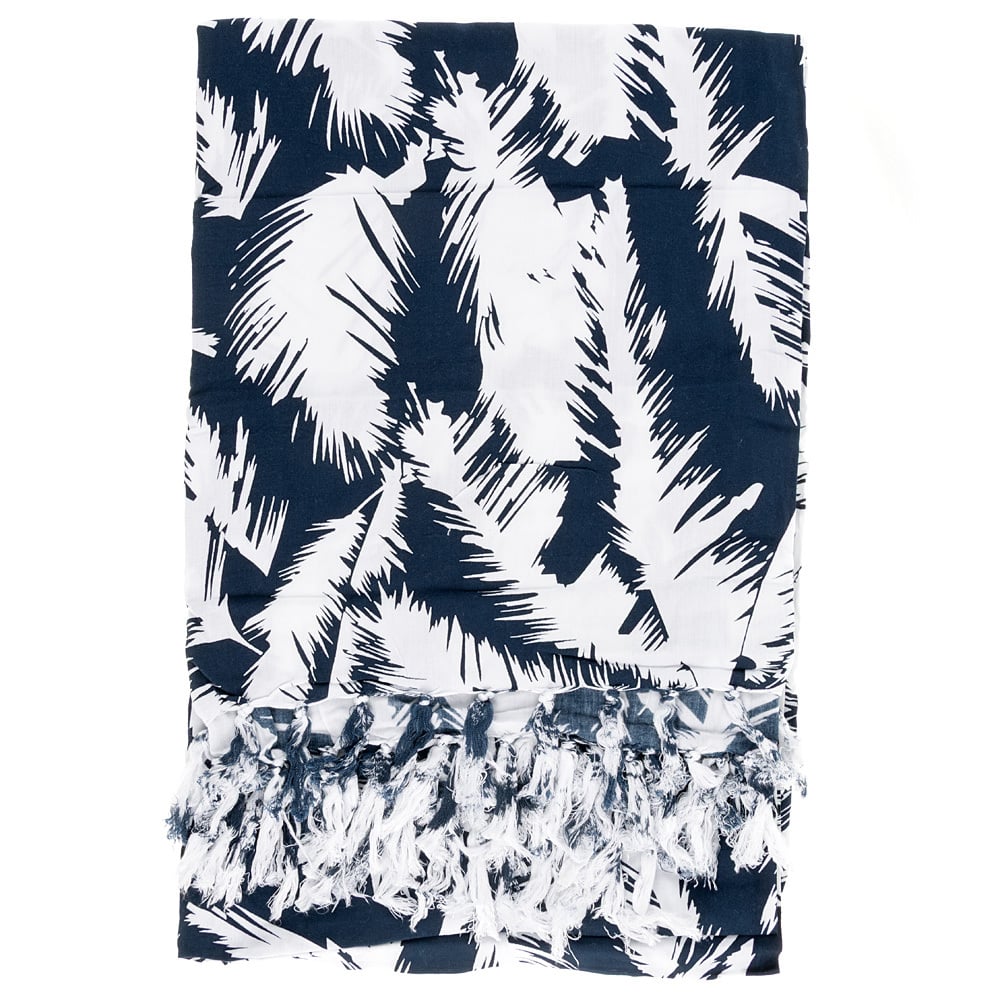 A navy blue and white patterned fabric with abstract leaf designs and knotted fringe tassels along one edge.