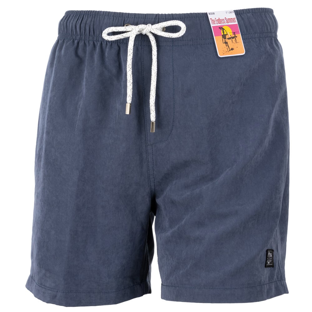 Blue drawstring swim shorts with a tag attached, featuring a pocket and metal-tipped laces.