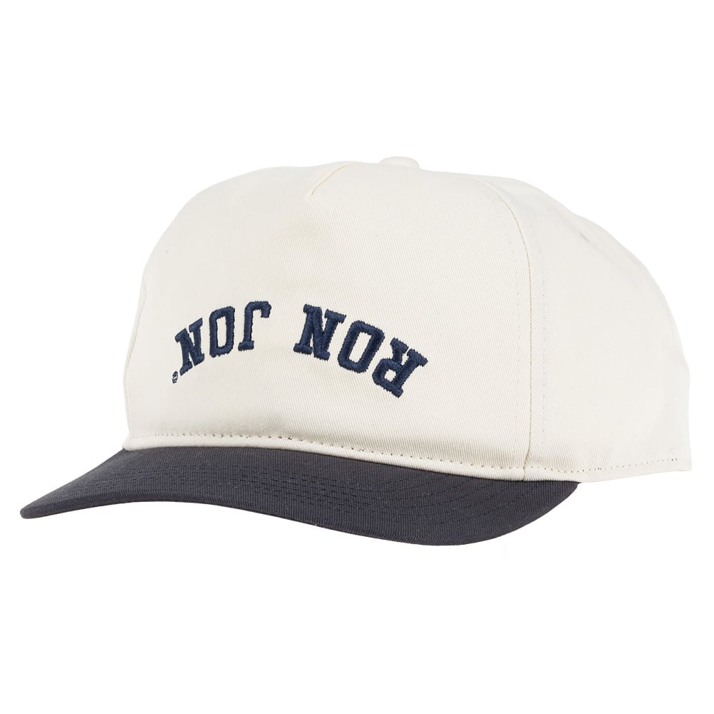 Beige baseball cap with a black brim and the words RON JON printed upside down in blue letters on the front.