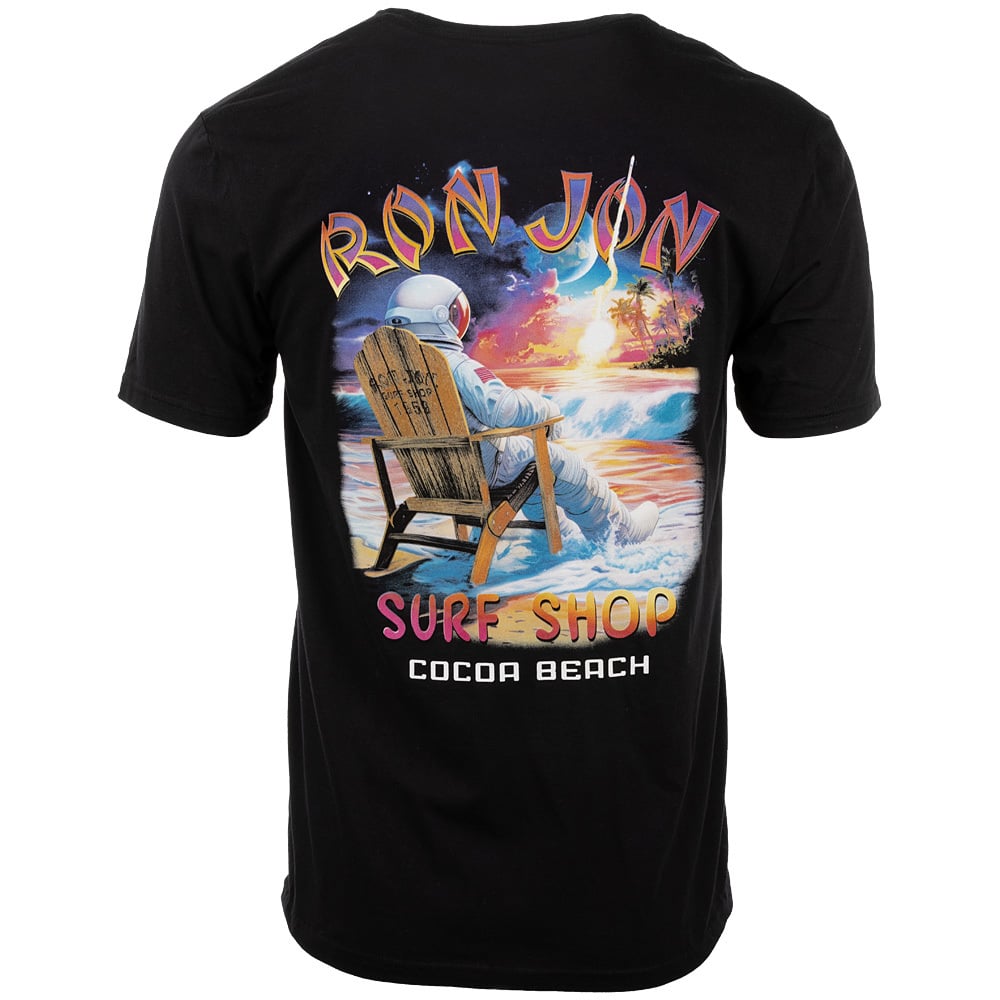T-shirt showing an astronaut sitting on a beach chair at sunset with the text Ron Jon Surf Shop Cocoa Beach.