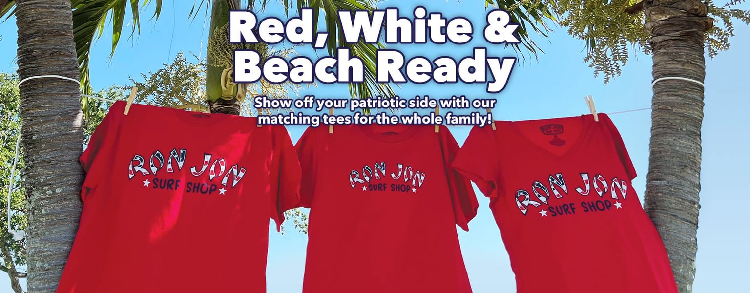 Three red Ron Jon Surf Shop t-shirts hang on a clothesline under palm trees with text promoting matching patriotic tees for families.