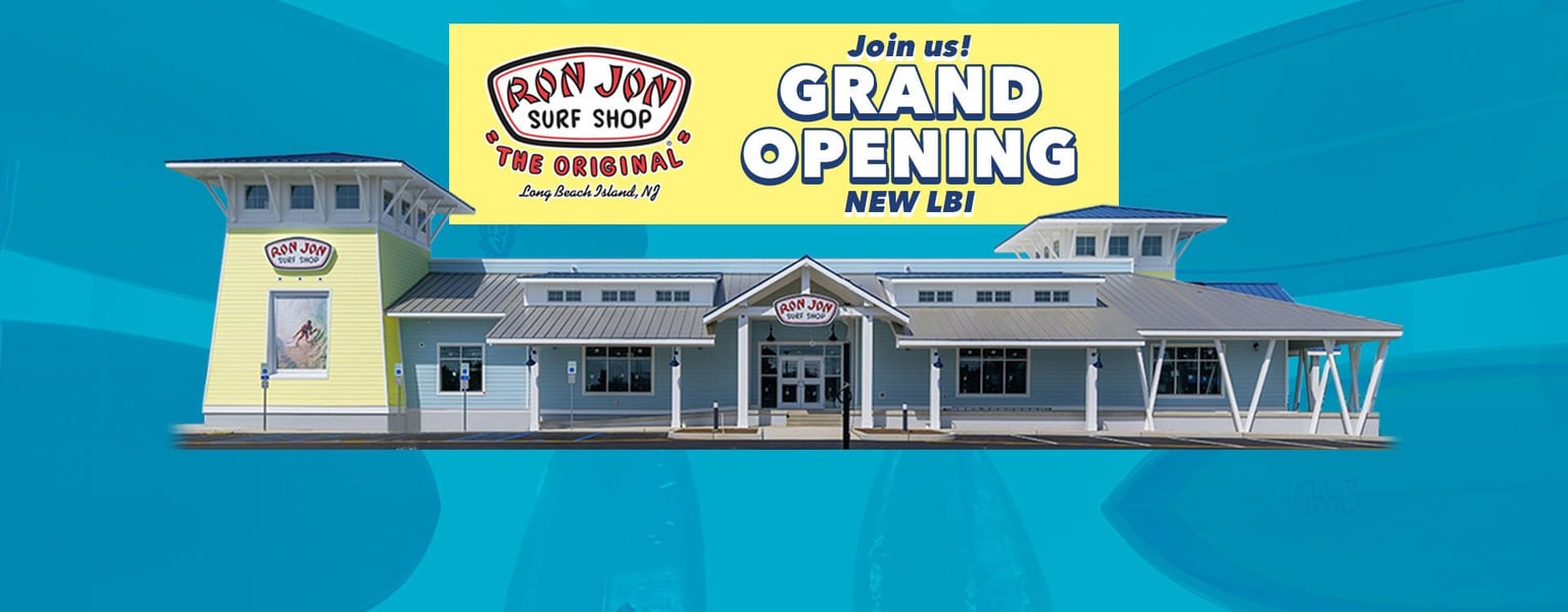 Exterior of Ron Jon Surf Shop with a large banner reading Join us! Grand Opening New LBI displayed above the entrance