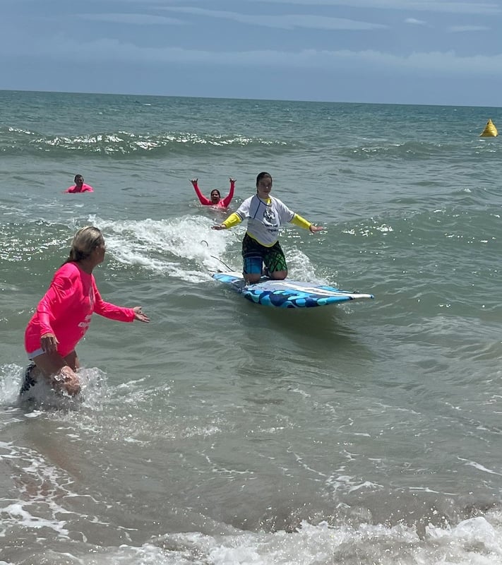 Special Olympics surfer on wave in competition